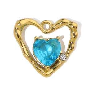Detailed view of a gold heart pendant with a sky blue gemstone and clear zircon accent