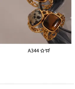 Macro detail of gold-plated twisted rings featuring square tiger eye and leopard stones