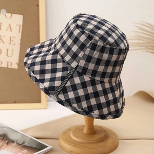 Japanese style black and white checkered foldable bucket hat on a wooden display stand
