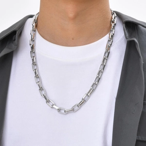 Close-up of a silver hip hop stainless steel square link chain necklace on a male model