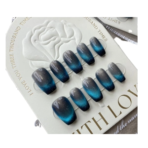 Blue cat eye press-on nails with shimmering magnetic gradient in mid-long coffin shape