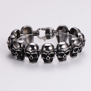 Close-up of vintage silver skull link bracelet with detailed gothic punk metalwork