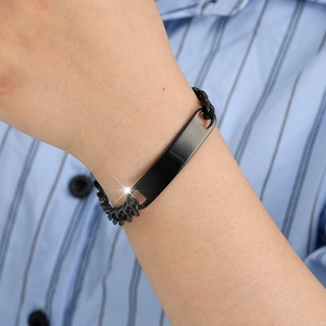 Close-up of a sleek black stainless steel chain bracelet with a blank bar on a wrist