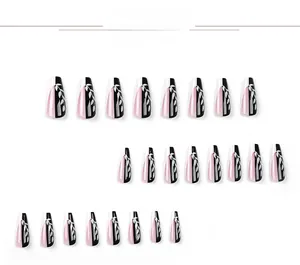 Detail view of 24pcs pink and black coffin press-on nails with white leaf pattern