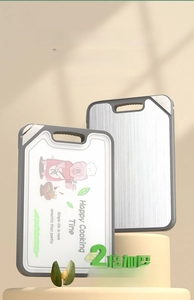 Close-up of double-sided cutting board showing stainless steel and plastic surfaces