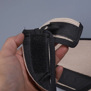 Detail of adjustable hook and loop fastener on lightweight linen blend sun visor hat