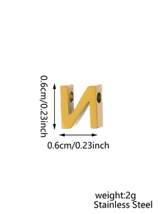 Detail view of golden stainless steel letter N charm with 0.6cm dimensions and zircon inlay