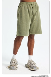 Detail of vintage olive green heavy cotton shorts with elastic drawstring waist and pockets