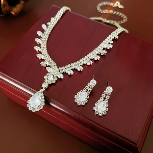 Sparkling waterdrop zirconia necklace and earring set displayed on a luxury red wood gift box