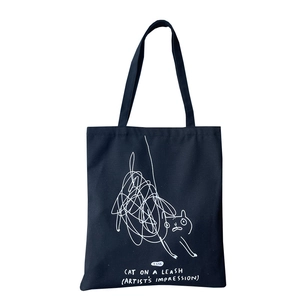 Minimalist navy blue canvas tote bag with artistic white cat graffiti illustration and straps