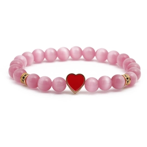 Pink cat eye beaded bracelet with red heart pendant and gold crystal spacers