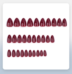 Macro display of 30 pieces of glossy burgundy almond-shaped press-on nails in various sizes