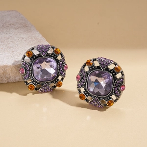 Macro shot of vintage geometric square earrings with purple stones and amber crystals