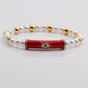 Multicolor evil eye beaded bracelet with white pearls and gold accents on grey mirror
