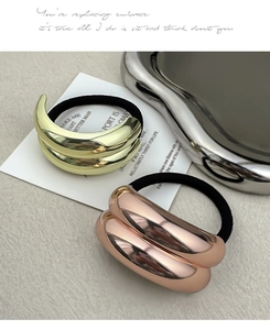 Detail of wavy gold and rose gold metal hair ties with high-elasticity black rubber bands