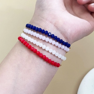 Set of four colorful faceted bead bracelets in red, pink, blue, and white for women