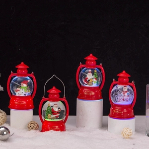 Close-up of lighted red Christmas snow globe lanterns with Santa and snowman motifs