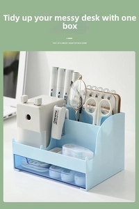 Close-up of a light blue desk organizer with multiple compartments and a transparent drawer