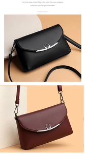 Detail of lychee pattern leather bags in black and burgundy with heart ring buckles