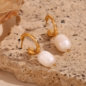 Detail of 18K gold-plated hoop earrings with natural white freshwater pearl pendants