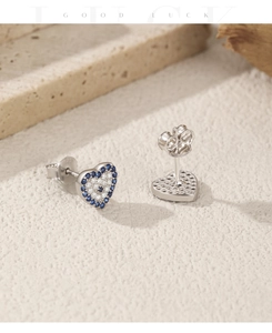 Macro detail of S925 sterling silver heart earring with blue and white pavé cubic zirconia