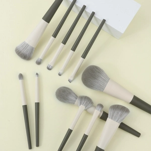 Macro view of 12 travel makeup brushes with soft fiber bristles and olive green handles