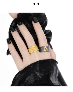 Detailed close-up of gold and black gold irregular textured rings with diamond accents