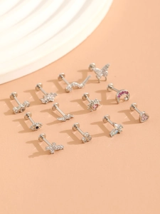 Detailed close-up of silver nose rings featuring heart, butterfly, and moon charms with zircons