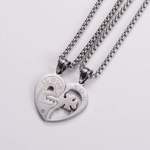 Detail of silver heart-shaped puzzle necklace set for couples in polished stainless steel
