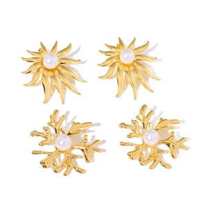 Golden coral branch and sunburst earrings with inlaid white pearls on white background