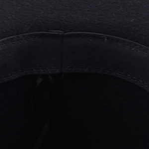 Detailed macro view of the interior black sweatband and stitching on wool fedora hat