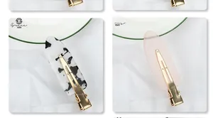 Detailed view of 6cm hair clips in marble white and translucent pink with gold metal finish
