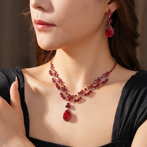 Detail of vintage red teardrop zirconia necklace and earrings set on model