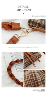 Detail of woven leather strap and gold metal hook on plaid tweed bucket bag