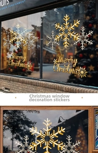 Detail of gold snowflake stickers and Merry Christmas lettering on a glass window