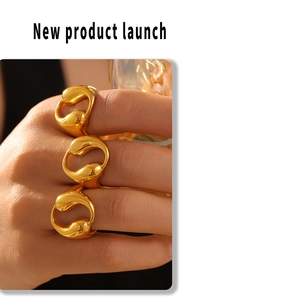 Close-up of three 18k gold plated hollow teardrop rings with organic shapes on fingers