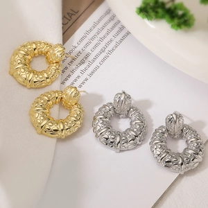 Textured round pendant earrings in gold and silver finish with embossed hammered surface
