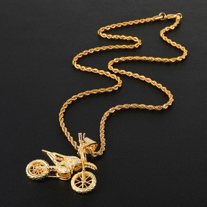 Detailed view of a gold-plated iced-out motorcycle pendant with a twisted rope chain