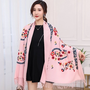 Detailed view of pink pashmina scarf featuring colorful floral embroidery and soft tassels