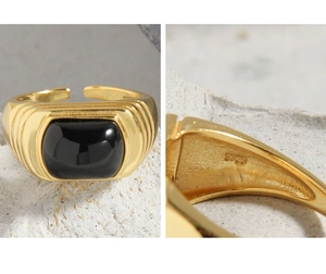 Macro shot showing S925 sterling silver stamp and black onyx on vintage gold ring