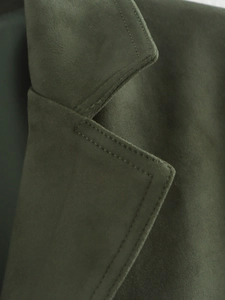 Detail of dark green faux suede blazer showing premium texture and reinforced stitching