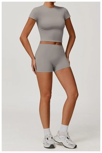 Detail of gray two-piece yoga set featuring round neck crop top and high-waisted shorts