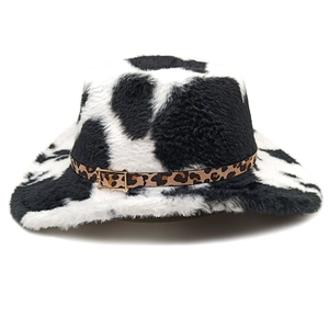 Détail du chapeau de cowboy imprimé vache avec texture peluche et boucle dorée