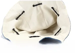 Close-up of beige bucket hat interior showing neat stitching and adjustable drawcord