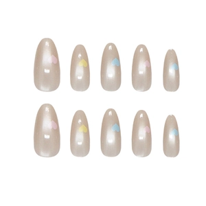 Handmade almond press-on nails with dopamine candy hearts and pearlescent champagne gold finish