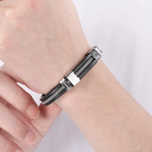 Close-up of titanium steel silicone men's bracelet with silver buckle and black layered strap