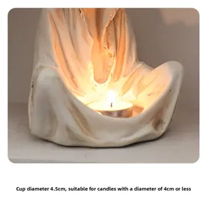 Macro view of white resin ghost candle holder with 4.5cm opening and lit tea light