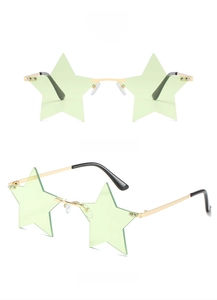 Detail view of star-shaped rimless sunglasses with green lenses and gold metal frame
