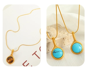 Detail of 18K gold titanium necklaces with turquoise and tiger eye round pendants