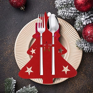 Close-up of red felt Christmas tree cutlery holder with silverware on a festive plate